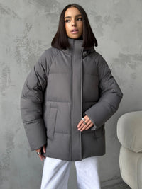 Damen Oversized Steppjacke mit Kapuze und integrierten Taschen in Grau