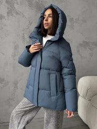 Damen Oversized Steppjacke mit Kapuze und integrierten Taschen in Blau
